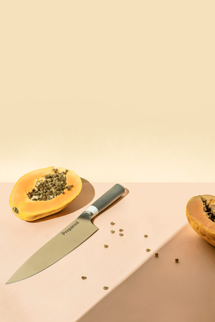 Chef's knife by prepare kitchenware with papaya that has been cut